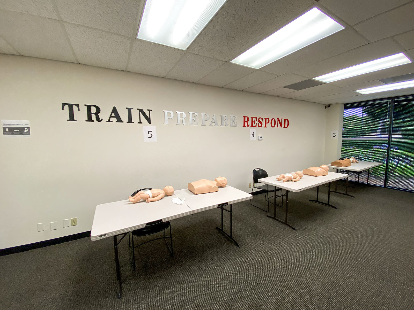 First Aid training room with two tables and CPR dummies.