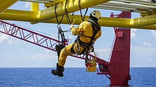 Construction worker using the proper fall protection equipment while working at a significant height